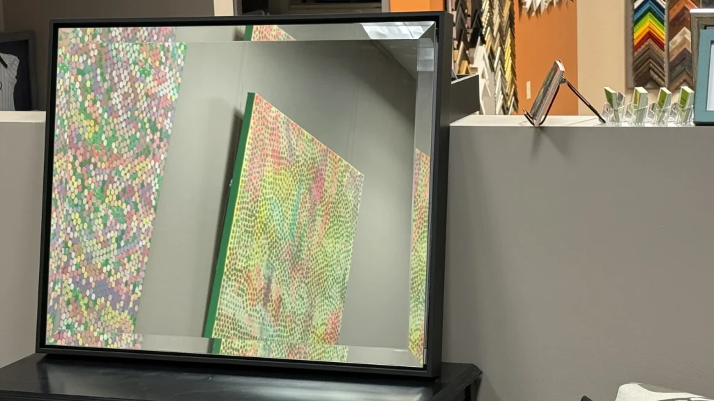 custom framed mirror Littleton CO modern black frame reflecting artwork in showroom